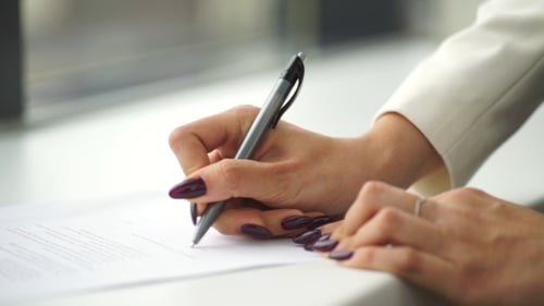 Woman Signing Document in Office Close Up
