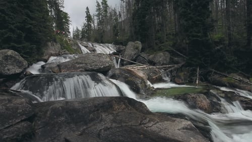 Mountain River with Cascade Waterfall in Forest