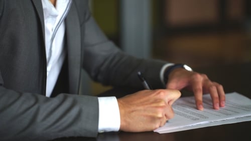 Man Signing a Business Contract at Work