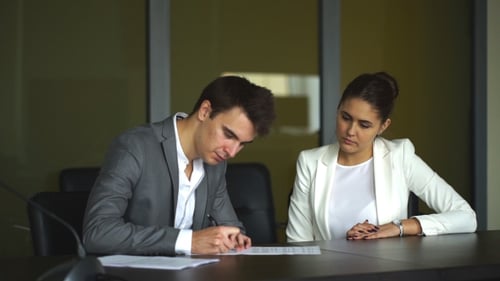 Cute Businesswoman Getting His Client To Sign a Contract and Close a Deal During a Meeting