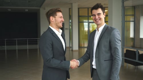 Two Businessmen Met in the Office and Shake Hands