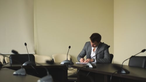 Business Meeting: Man Signing Documents in Office