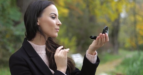 Woman Looking at Pocket Mirror