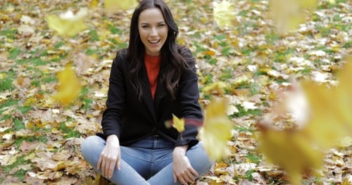 Happy Woman and Falling Leaves