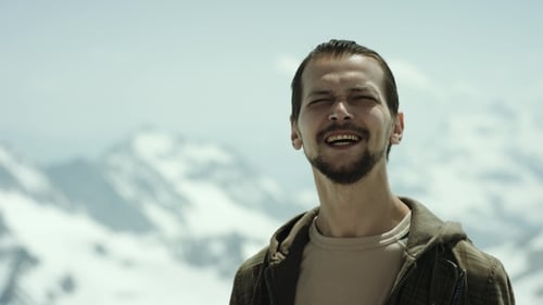Young Bearded Man at Mountain Pinnacle with Scenic View Squint Eyes and Talking
