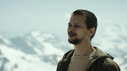 Young Bearded Man at Mountain Apex with Scenic View Squint Eyes and Talking