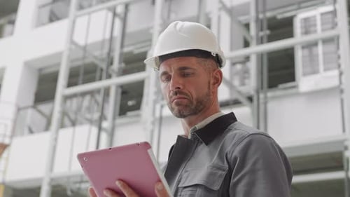 Caucasian Builder Using Tablet Computer