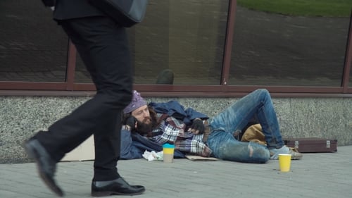 Businessman Giving Money To Homeless
