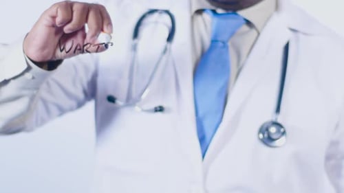 Doctor Writes "Warts" on Transparent Screen