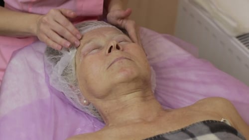 Adult Receiving a Facial Massage in Spa
