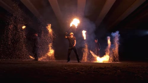 Skilled Young Adults Fire Spinning at Night