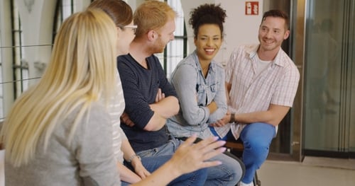 Diverse Group Engaged in Cheerful Discussion