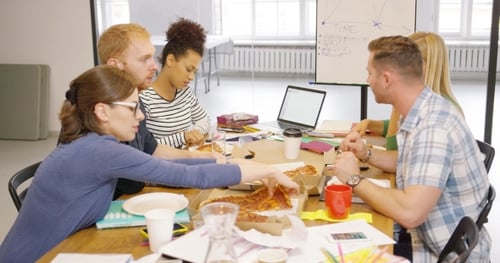 Team Sharing Pizza During Office Meeting