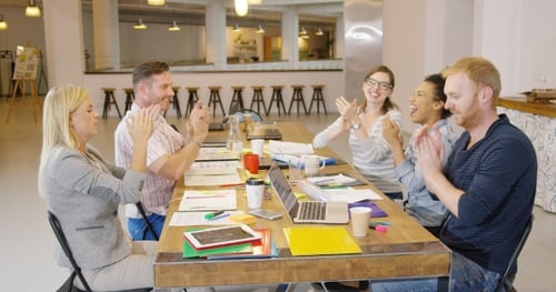 Colleagues Celebrate Success with High Five and Applause