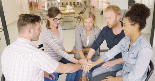 Colleagues Holding Hands Together