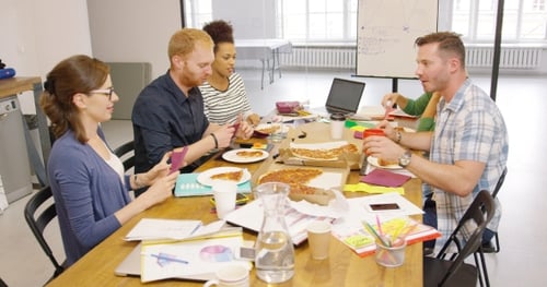 Creative Team Eating Pizza in Modern Office