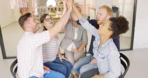 Young Adults Cheering in Airy Modern Office