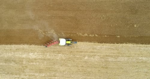 Agricultural Tractor Plowing Field
