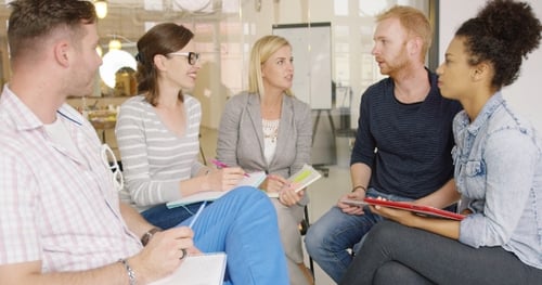 Colleagues Listening To Bearded Man