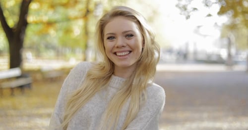 Happy Woman in Autumn Park