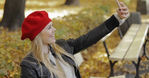Woman in Beret Taking Selfie in Park