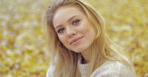 Beautiful Woman in Autumn Park
