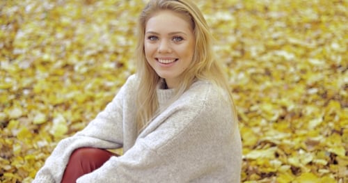Happy Woman Sitting on Ground