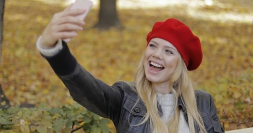 Happy Woman Taking Selfie in Park