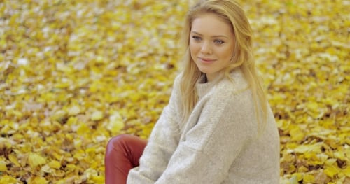 Thoughtful Woman Sitting on Ground