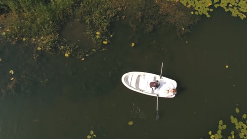 Top View on Loving Couple in a Boat on the Lake