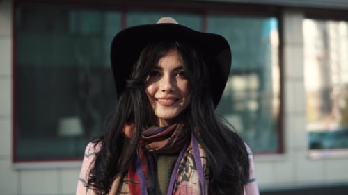 Stylish Woman Smiling in Urban Fashion Portrait