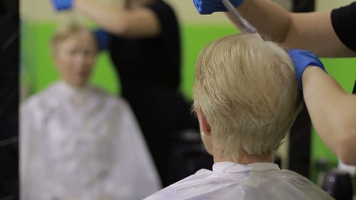 Woman Dyes Her Hair in Beauty Salon