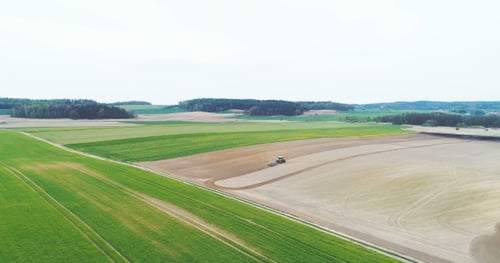 Tractor Working in Rural Farm Field Aerial