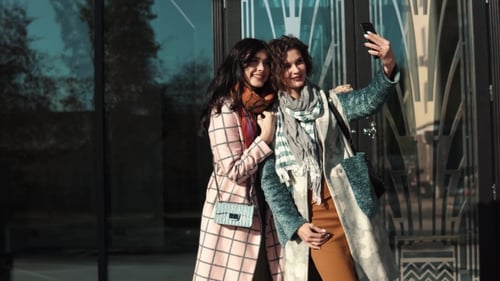 Girlfriends Make Selfie on a Mobile Phone in the City.