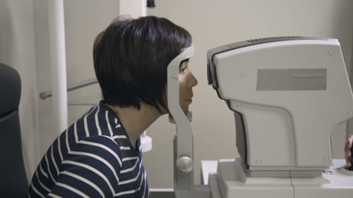 Ophthalmologist Examines Patient's Eyes in Clinic
