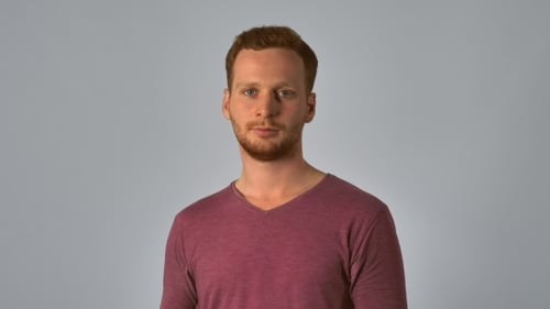 Young Man Clapping Against Neutral Background
