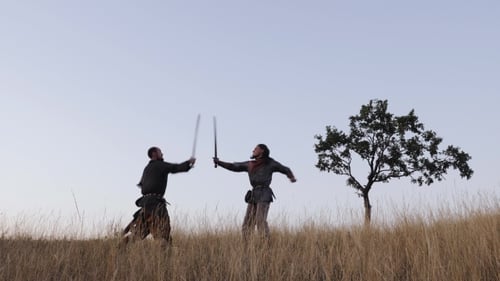 Men Sword Fighting on Rural Grassy Hill