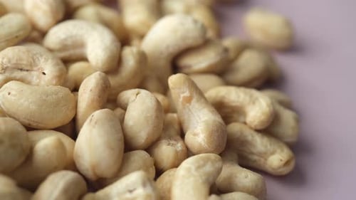 Close Up of Cashews on Purple Background