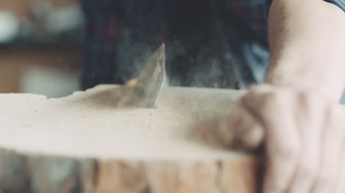 Carpenter Cutting Wood With Handsaw In Workshop