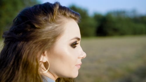 Woman with Wavy Hair Profile in a Field