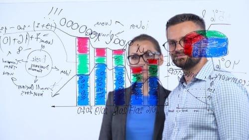 Un homme et une femme discutent de la stratégie commerciale pour réussir dans un bureau vitré moderne