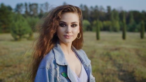 Woman with Curls Poses in Rural Field