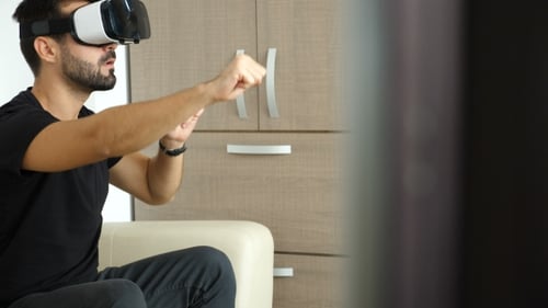 Businessman Is Taking a Break in His Office Using the VR Headset Technology