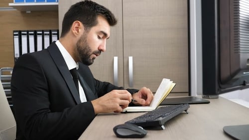 . Young Businessman Checking His Watch and Then Realising He Is Late