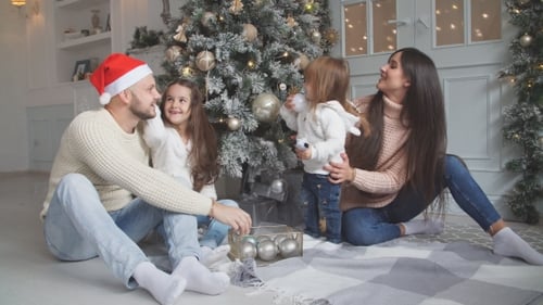 Happy Family Decorating Christmas Tree Together at Home