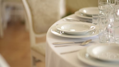 Elegant Wedding Table Setting with Plates and Glassware