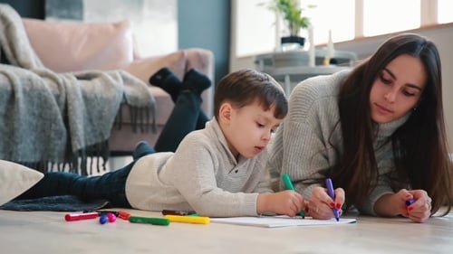 Child and Woman Drawing Together at Home