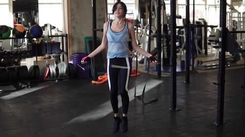 Skipping Woman Training at the Gym Working Out. Fit Young Woman Skipping Rope