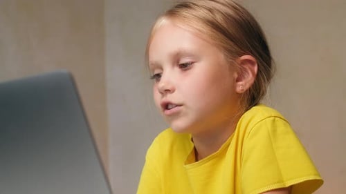 Girl Using Laptop Computer at Home