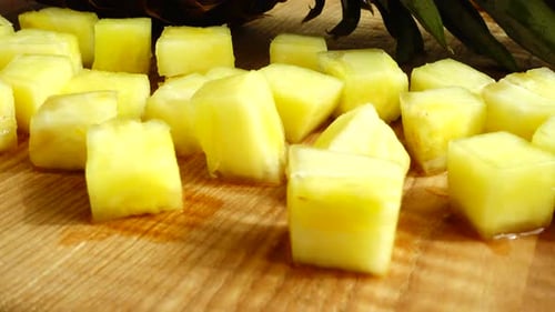 Fresh Pineapple Chunks on a Wooden Cutting Board